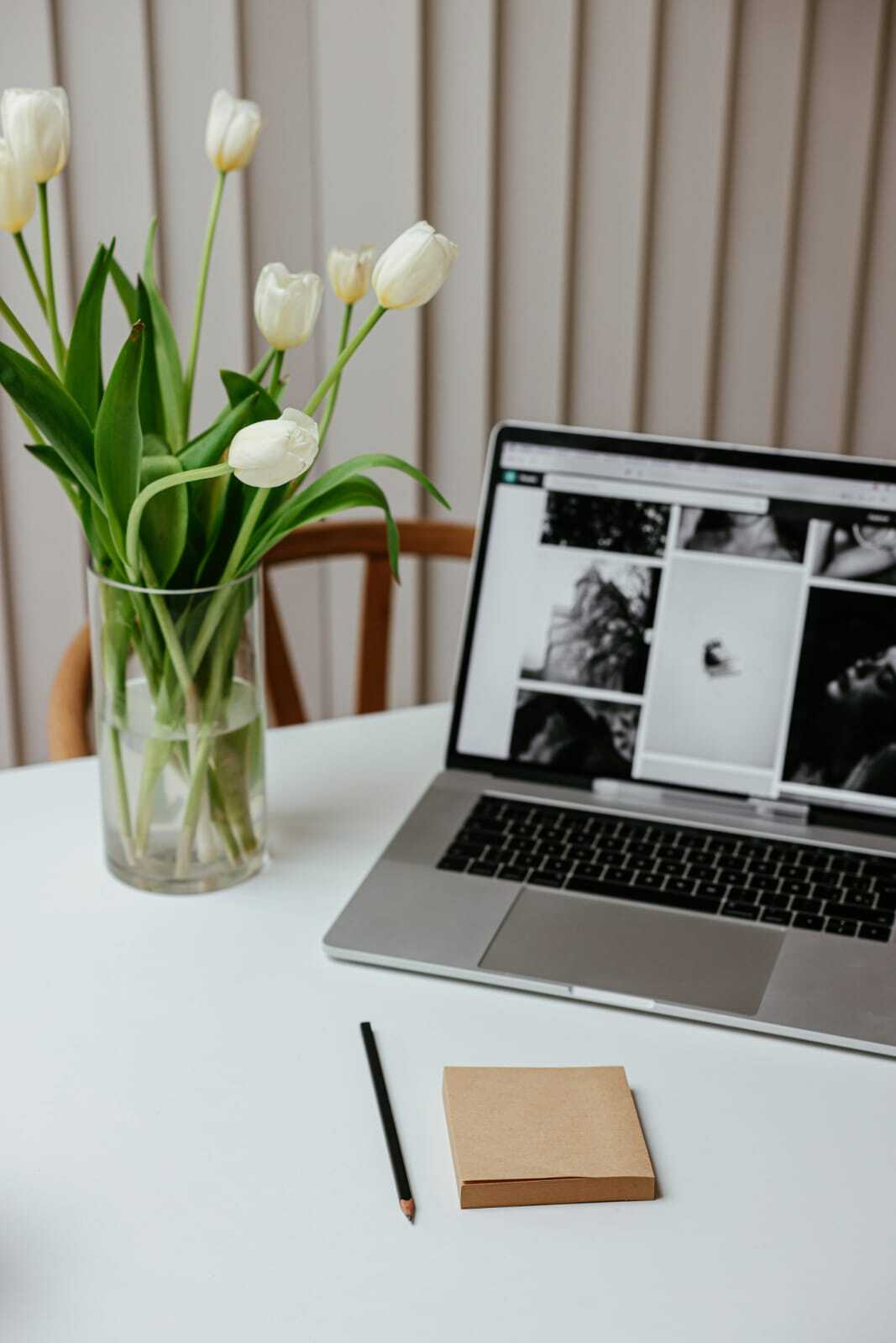 laptop open with tulips by it