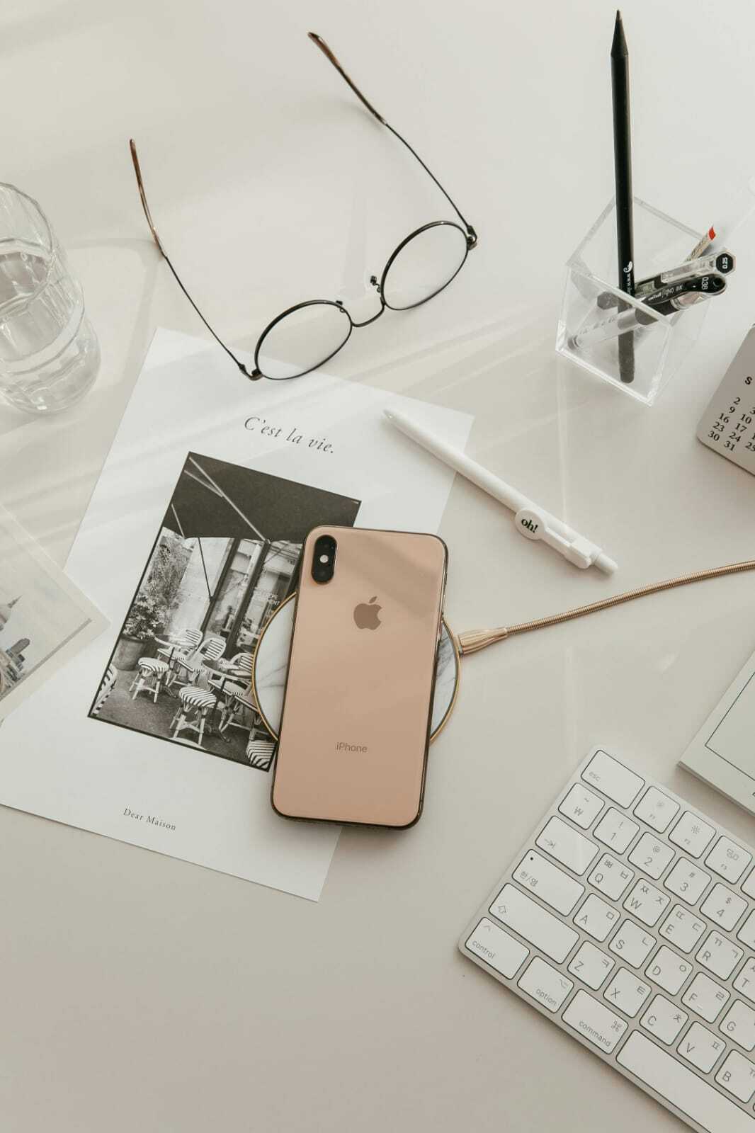 phone and keyboard layed out on a desk